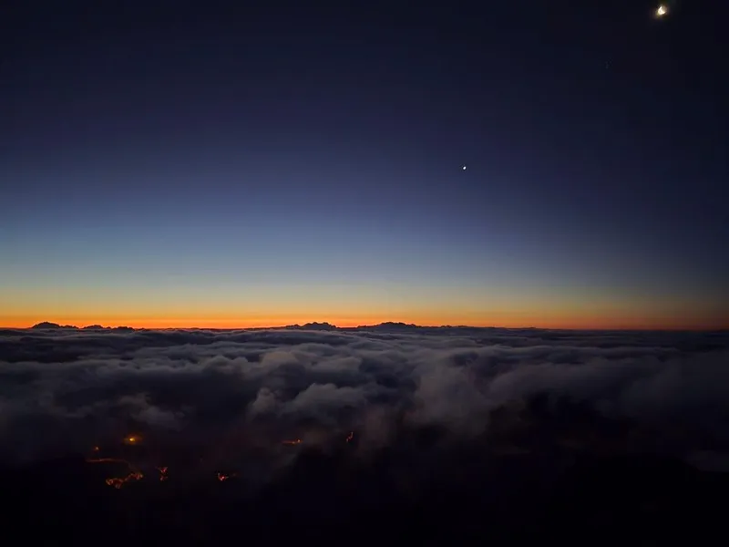 The sun rising over a sea of clouds seen from the summit of Pico do Arieiro on a Madeira sunrise tour in Pico do Arieiro, Madeira